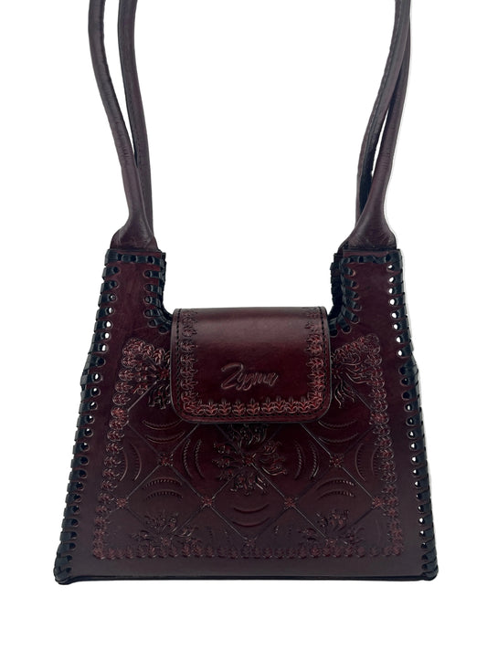 Brown leather strap with intricate designs on a white background