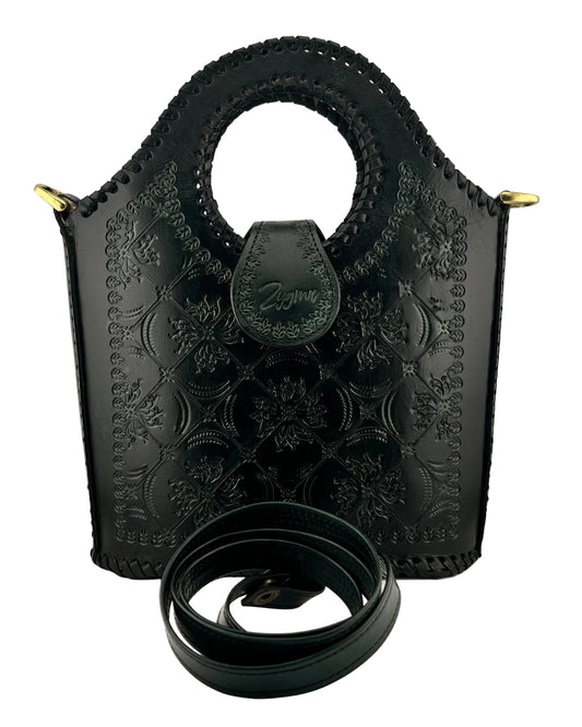 green leather handbag with intricate patterns and a matching belt on a light gray background