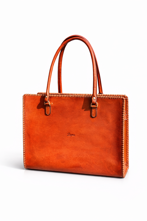 tan leather tote bag on a white background