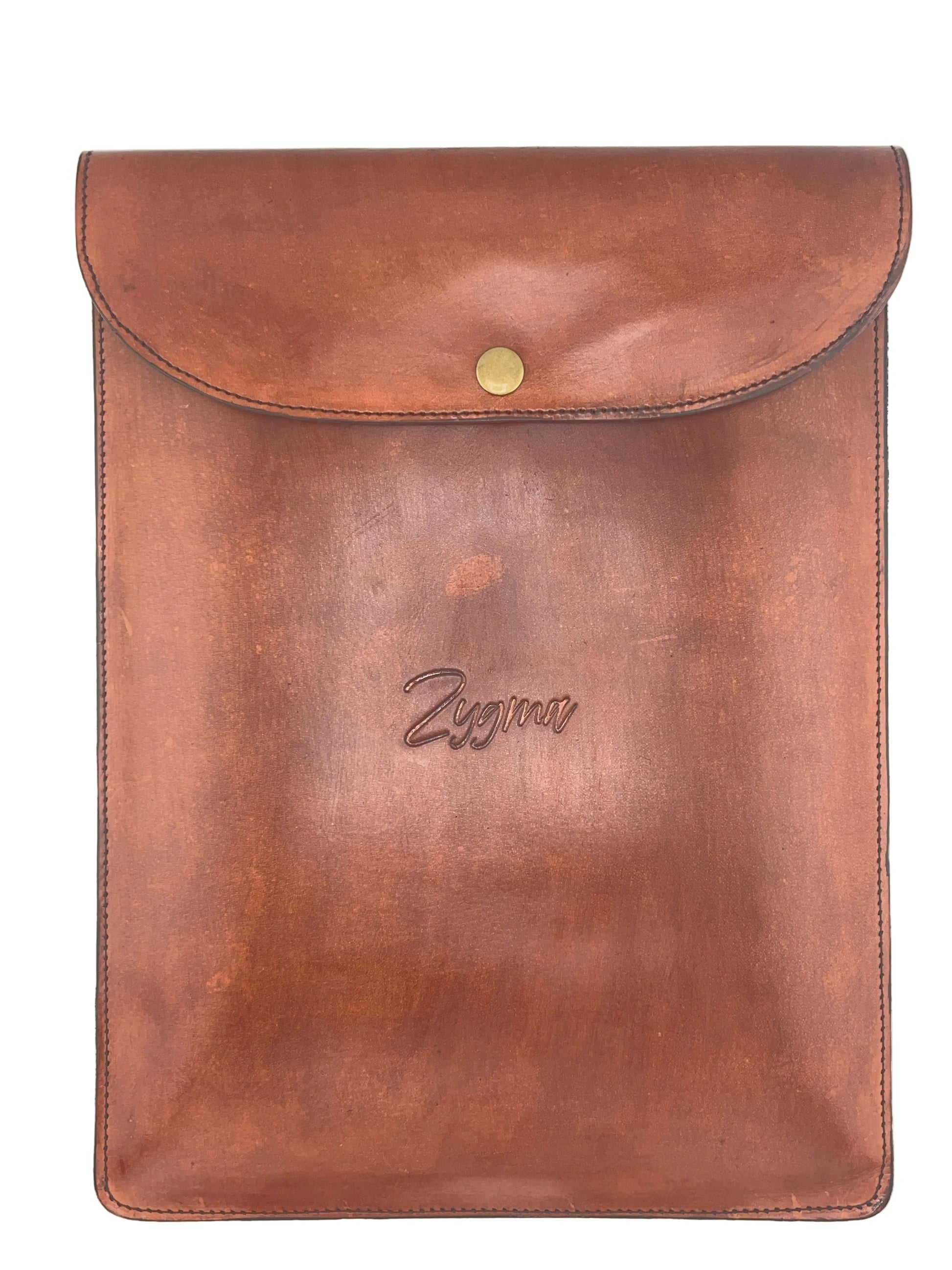 A brown leather sleeve or pouch with a flap closure and a small gold-tone snap button, photographed flat against a light neutral background. The word 'Zyona' is embossed near the center.