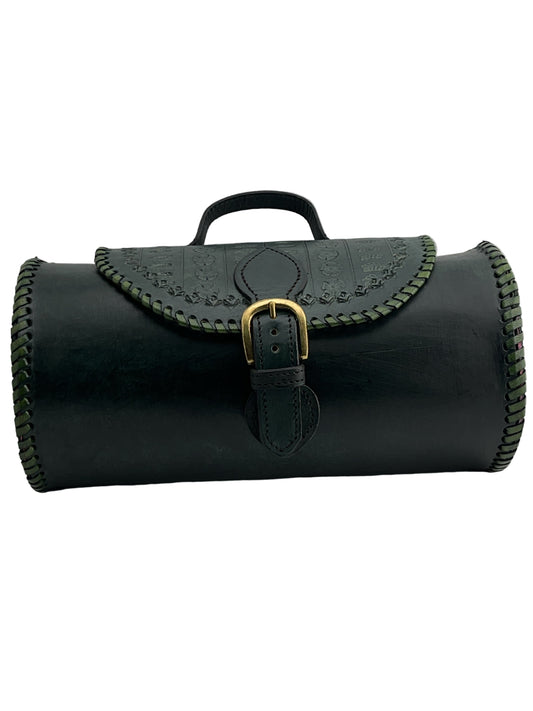 green leather roll with gold buckle on a light gray background