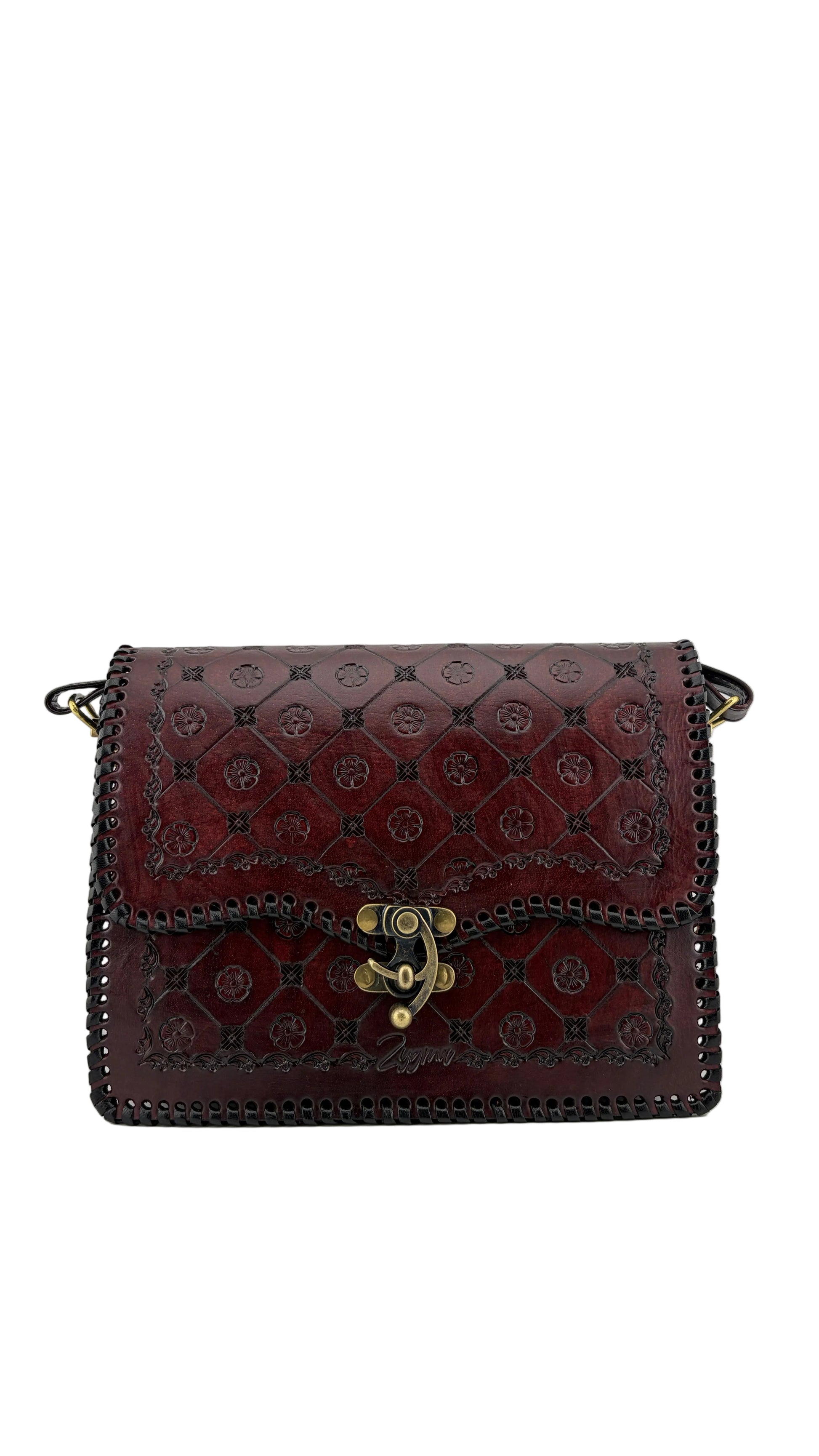A dark burgundy leather shoulder bag with an embossed geometric pattern and gold-tone hardware, displayed inside a white box.
