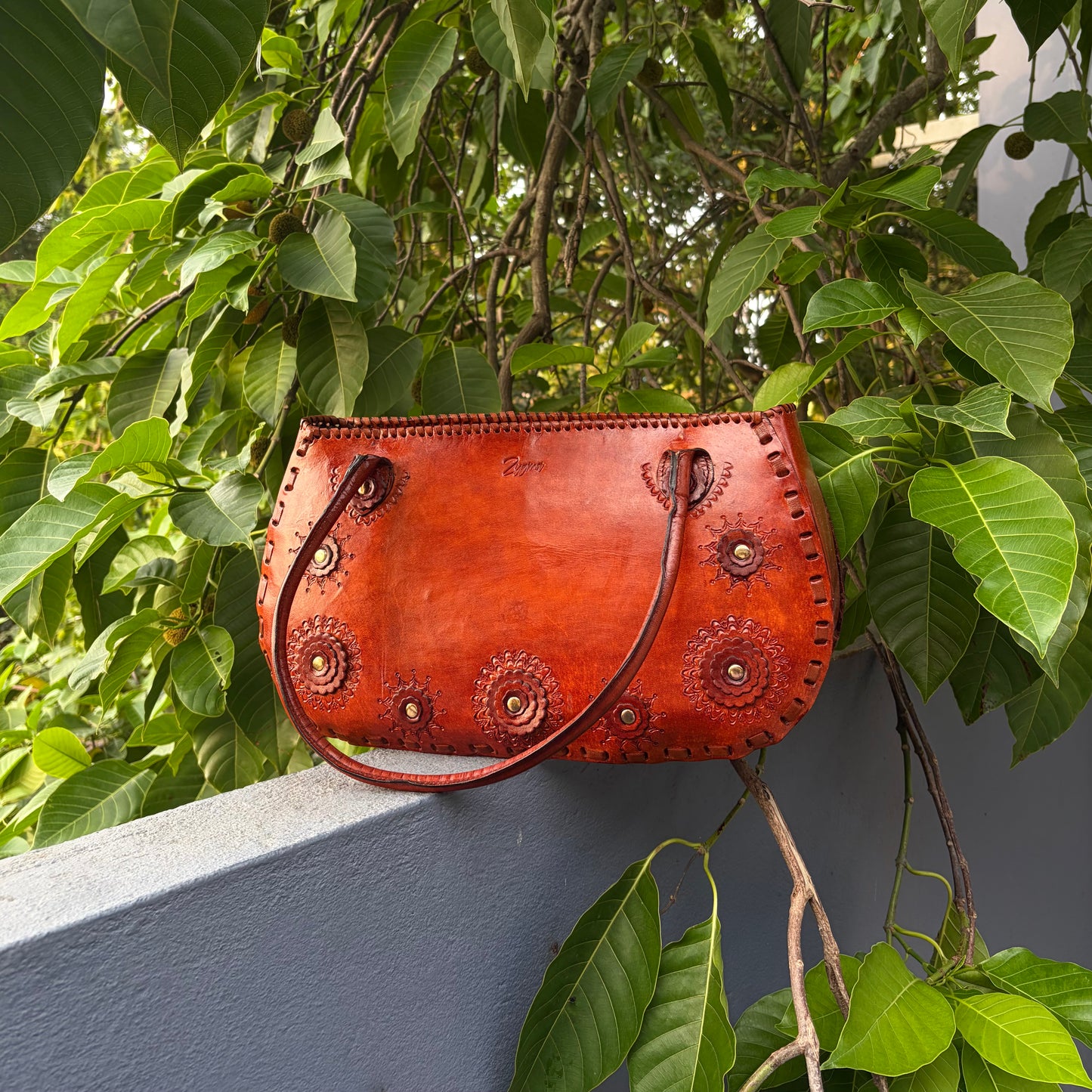 Zygma Hand-Carved Rosette Half-Moon Handbag — Cognac Tan