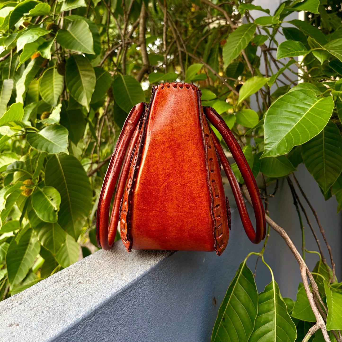 Zygma Hand-Carved Rosette Half-Moon Handbag — Cognac Tan