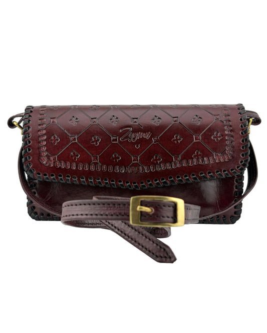 Brown leather handbag with gold buckle on a white background