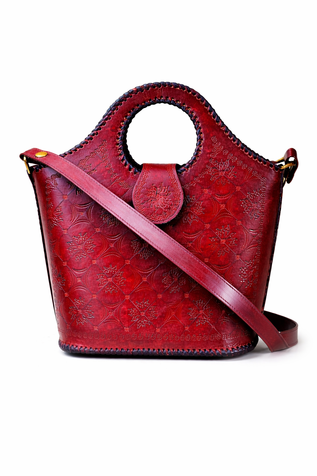 Red leather handbag with floral patterns on a white background